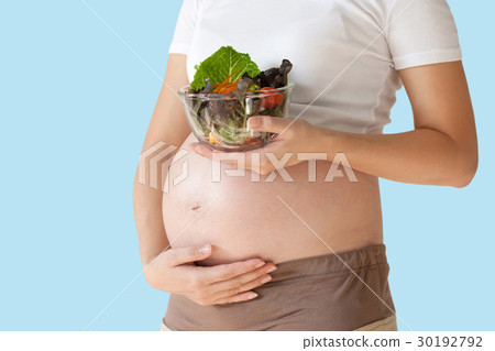 Pregnant woman's belly and vegetable 30192792
