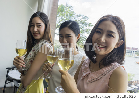 Ladies are enjoying their time with champagne in a restaurant 30193629
