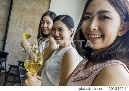 ladies are happy with champagne in restaurant ladies are happy with champagne in restaurant 30193634