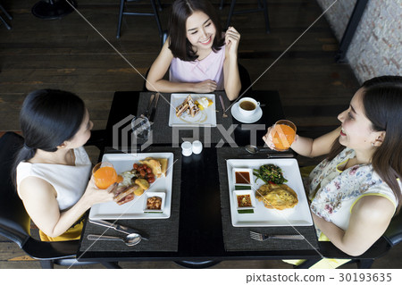 Ladies are happy with delicious meal in restaurant Ladies are happy with delicious meal in restaurant 30193635