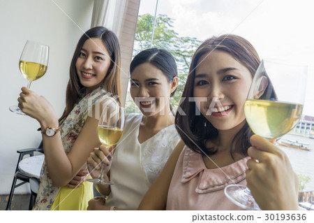 A photo of ladies enjoying holiday with champagne in restaurant 30193636