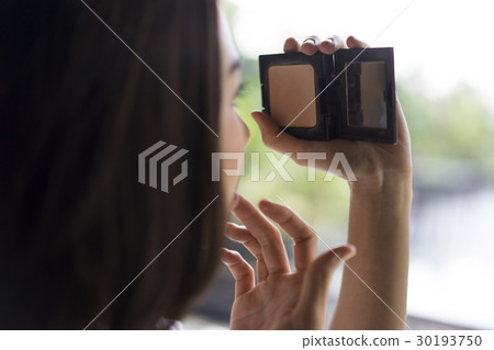 A young girl is doing her make-up A young girl is doing her make-up 30193750