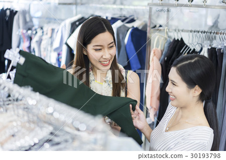 A woman is choosing pants. A woman is choosing pants. 30193798