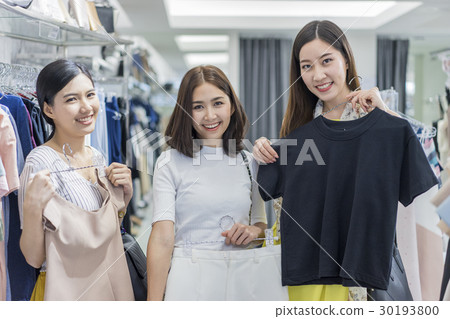 A group of women are trying clothes in the store. 30193800