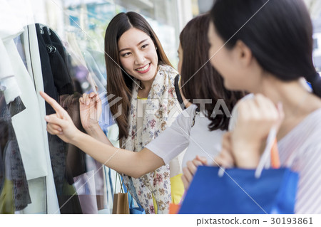 A group of women window shopping in shopping mall. 30193861