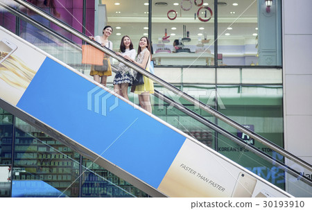 Photo of women are on the elevator in a shop. 30193910