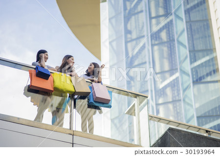 Adorable girls are talking together above the building. 30193964