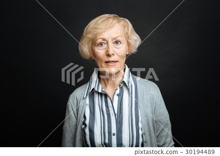 Angry old woman expressing discontent in the black 30194489