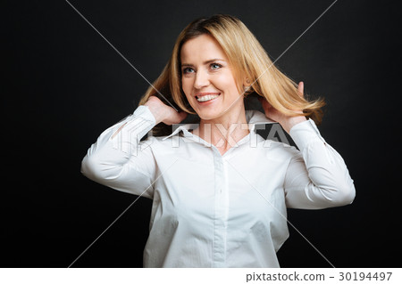 Charismatic mature woman smiling in the black 30194497