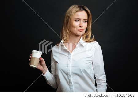 Attractive young woman enjoying cup of coffee in Attractive young woman enjoying cup of coffee in 30194502