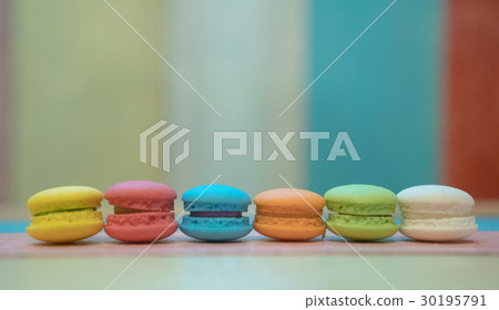 Multicolored macaroons on white wooden background Multicolored macaroons on white wooden background 30195791