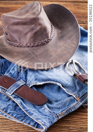 Jeans and leather hat on a wood board Jeans and leather hat on a wood board 30196022
