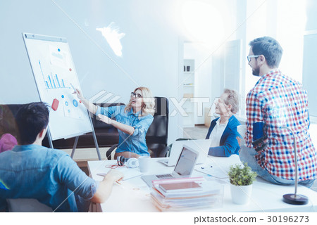 Pleasant woman discussing project with her 30196273