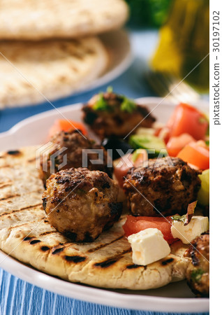 Greek meatballs (keftedes) with pita bread. 30197102