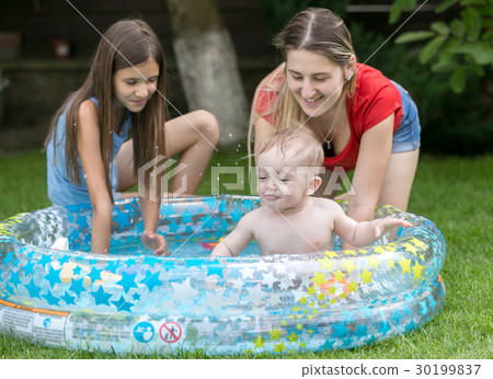 Baby swimming in outdoor pool with mother Baby swimming in outdoor pool with mother 30199837