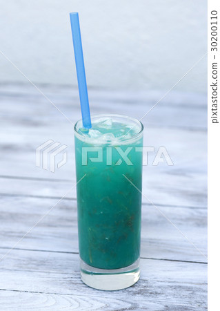 Blue lemonade in glass with ice and lemon on wood  30200110