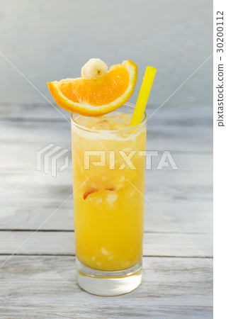 Orange juice in a glass with straw on wood Orange juice in a glass with straw on wood 30200112
