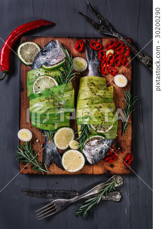 Still life with dorados wrapped in leek on the cut Still life with dorados wrapped in leek on the cut 30200290