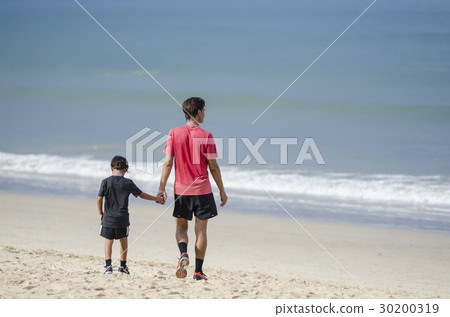 father and son walking and holding hands father and son walking and holding hands 30200319