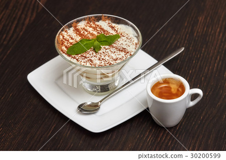 Tiramisu cake dessert in glass with mint leaves Tiramisu cake dessert in glass with mint leaves 30200599