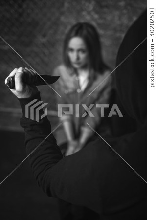 Barbaric evil abductor raising a knife 30202501