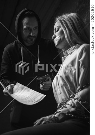 Evil greedy criminal making a hostage sign the 30202616