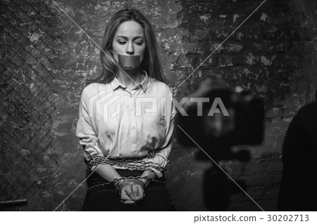 Greedy mad criminal filming a video for ransom 30202713