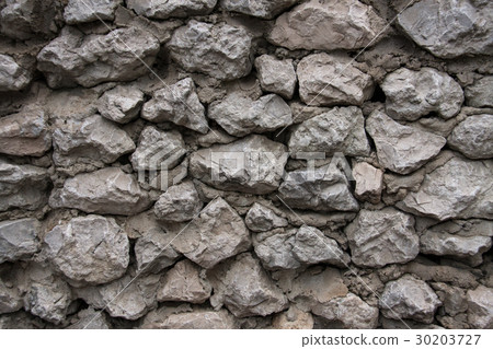 The wall made of gray stones and cement 30203727