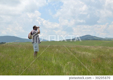 Man Looking Through Binoculars in a Landscape 30205870