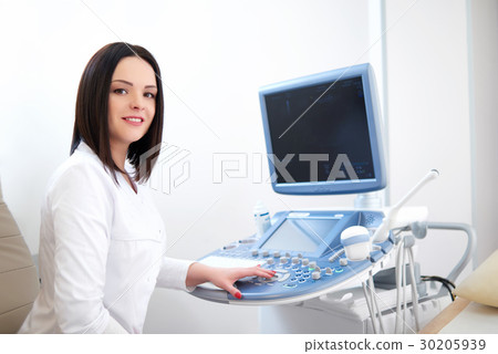 Beautiful female doctor sitting in her office near Beautiful female doctor sitting in her office near 30205939