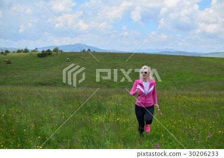 Woman Runs over Meadows and Hills Woman Runs over Meadows and Hills 30206233