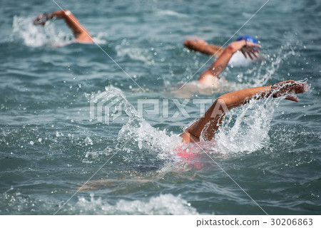 Swimming athletes in a triathlon contest 30206863