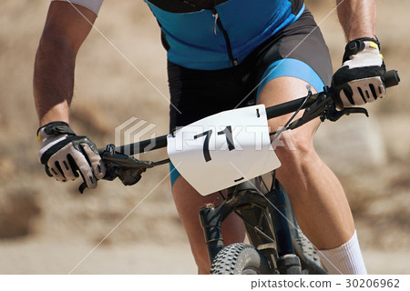 The torso of a man riding a mountain bike The torso of a man riding a mountain bike 30206962