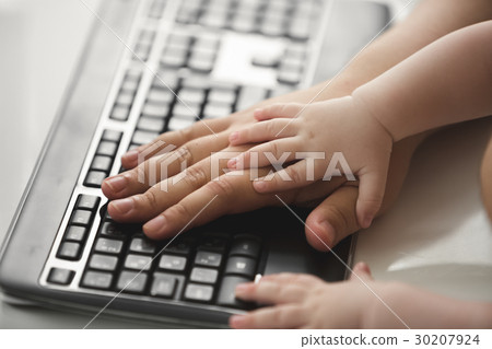 Fathers and baby's hands on computer keyboard 30207924