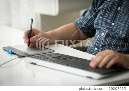 Man using digital graphic tablet and keyboard Man using digital graphic tablet and keyboard 30207935