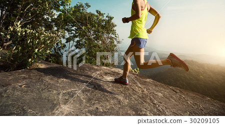 woman trail runner running at mountain top 30209105