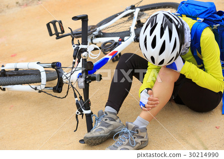 female cyclist getting injured on forest trail 30214990