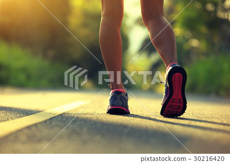 woman running on morning tropical forest trail 30216420