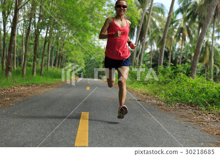 woman running at morning tropical forest trail 30218685