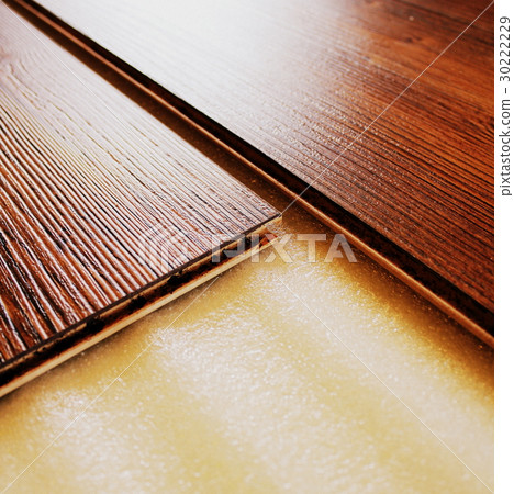 Brown laminate floor planks intalling , close up Brown laminate floor planks intalling , close up 30222229