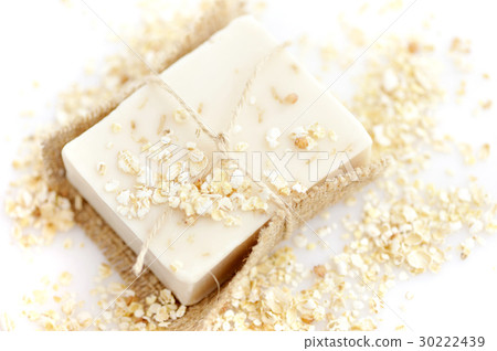Handmade soap with oatmeal and milk on a white Handmade soap with oatmeal and milk on a white 30222439