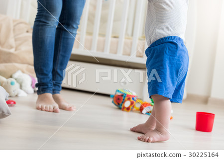 10 months old baby boy making first steps at home 10 months old baby boy making first steps at home 30225164