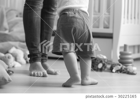 Image of 10 months old baby boy walking to his mom Image of 10 months old baby boy walking to his mom 30225165