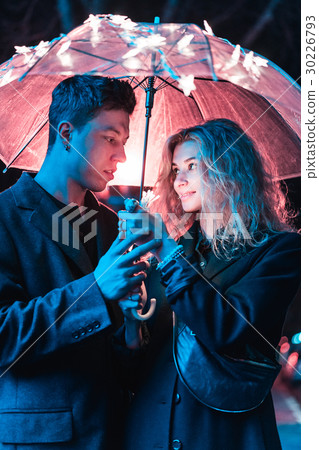 Portrait of a guy and a girl under an umbrella 30226793