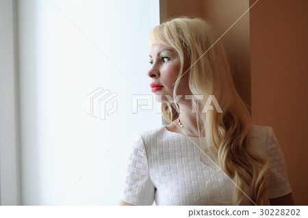 cute girl with blond hair by the window cute girl with blond hair by the window 30228202