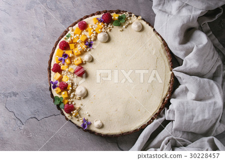 Chocolate tart with mango and raspberries 30228457