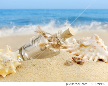 Summer sandy beach concept with letter in bottle 30229992
