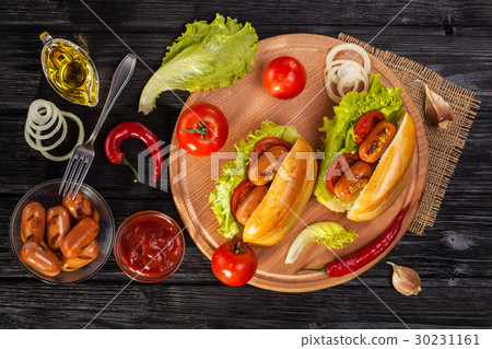 Hot dog with Tomato, lettuce, Sausage, mustard 30231161