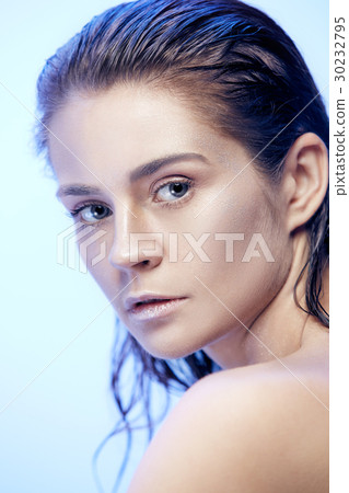 Beautiful woman face portrait close up on blue 30232795