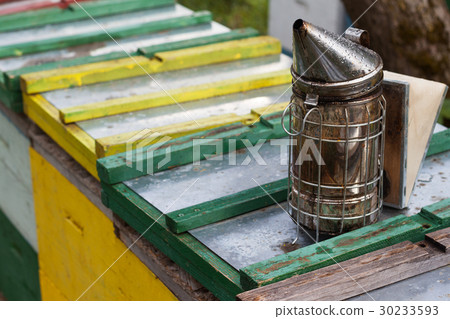 bee smoker on top of beehives boxes 30233593
